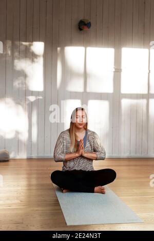 Woman practicing yoga in studio Stock Photo