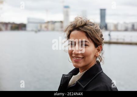 Portrait of smiling woman looking at camera Stock Photo