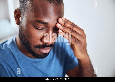 Exhausted male citizen is touching his forehead Stock Photo
