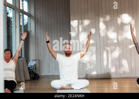People practicing yoga in class Stock Photo