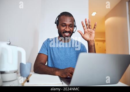 Afro-American male greeting the people in online conference Stock Photo