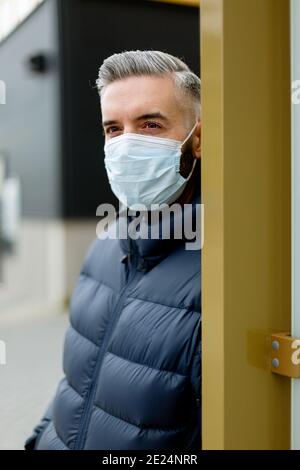 Man wearing face mask looking away Stock Photo