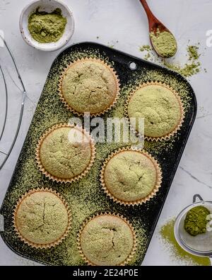 Overhead view of a tray of Matcha muffins sprinkled with matcha powder Stock Photo