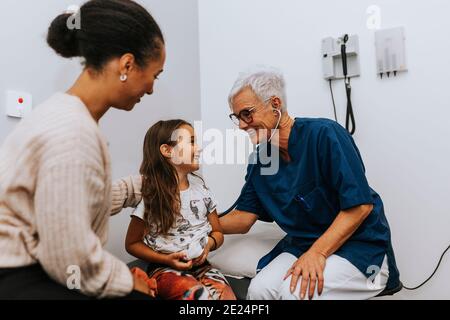 Mother with daughter in doctors office Stock Photo