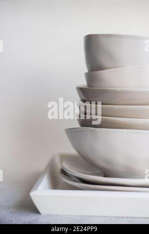 Stack of minimalist bowls and plates on a tray Stock Photo