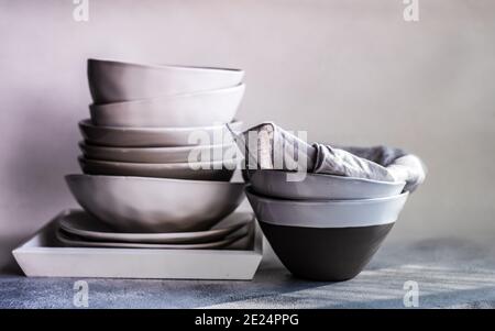 Stack of minimalist bowls and plates on a tray Stock Photo
