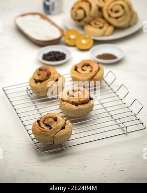 Cinnamon Rolls on a wire cooling rack Stock Photo