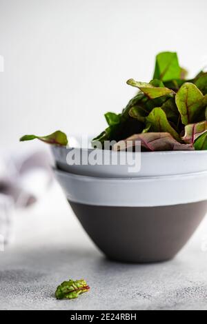 Beetroot leaves in ceramic bowls Stock Photo