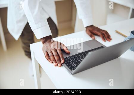 Hands of a medical person lying on a computer Stock Photo