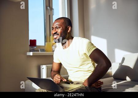 Afro-American male is squinting from the sun Stock Photo