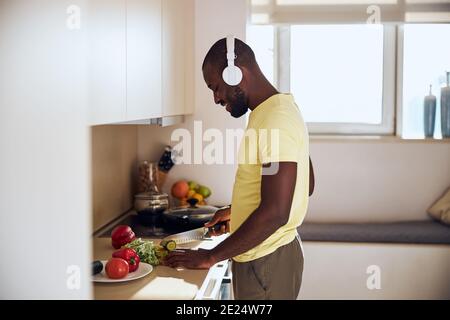 Cook listening to music while preparing food Stock Photo