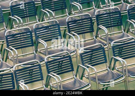 Outdoor view at several rows of blue steel chairs Stock Photo