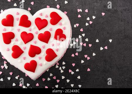 Heart cake for St. Valentine's Day, Mother's Day, or Birthday, decorated with sugar hearts on black background Stock Photo