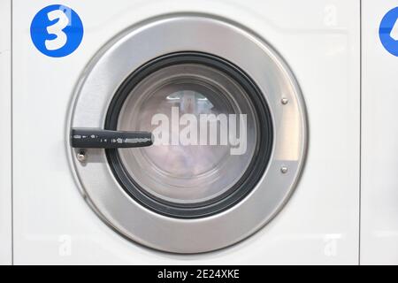 White Washing Machine At laundry front view Stock Photo