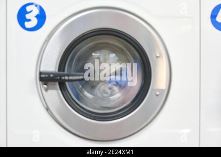 White Washing Machine At laundry front view Stock Photo