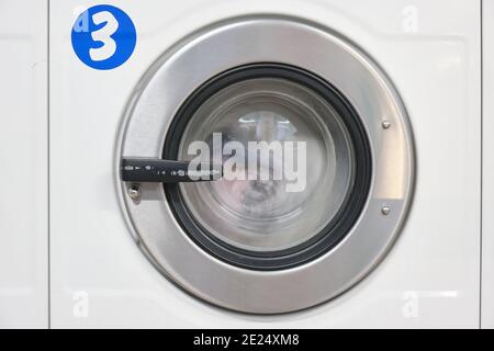 White Washing Machine At laundry front view Stock Photo
