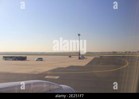 wing of an airplane on the airfield at the airport und blue sky Stock Photo