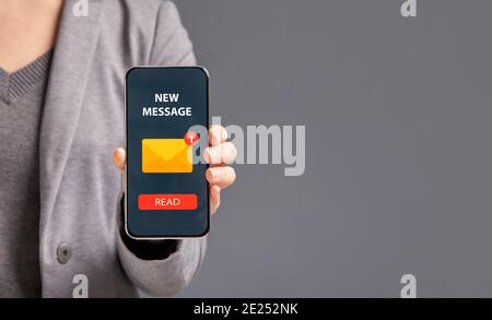 Digital Marketing Concept. Unrecognizable Businesswoman Showing Smartphone With New Message Notification Stock Photo