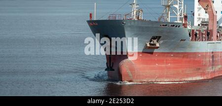 Closeup banner of multipurpose ship bulbous bow underway. Front view. Stock Photo