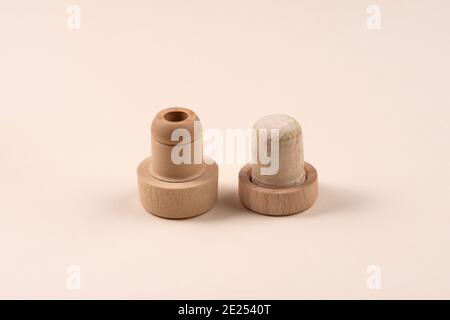 Two different bottle stoppers. One is natural, the other is plastic. The concept of alternative. Stock Photo