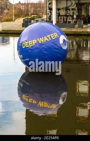 Walsall, West Midlands, UK. 12th January, 2021. The installers of a 6 foot diameter warning buoy in Walsall Basin canal in the West Midlands have applied to keep the deep water warning afloat for another five years. The Canal and River Trust claim that the 2 metre blue inflated sphere has saved many lives over the months it has has been there in the canal. Surrounding the canal basin are bars and restaurants as well as the Walsall New Art Gallery, and visitors and pub-goers often mistake the algae which grows in summer for grass - resulting in a few wet surprises. Peter Lopeman/Alamy Live New Stock Photo