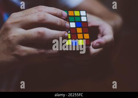 BANGA, PH– MAY 30, 2019: Rubik's Cube was invented in 1974 by Hungarian sculptor and professor of architecture Erno Rubik. Boy hands' solving the cube. Stock Photo