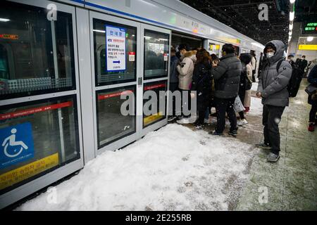 Seoul, Bucheon, South Korea. 12th Jan, 2021. Passengers pack a Seoul Subway Line 1 train at Sindorim Station, the most congested subway station in South Korea, as snow piles on the platform Tuesday, Jan. 1, 2021. Credit: Jintak Han/ZUMA Wire/Alamy Live News Stock Photo