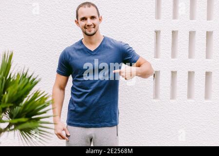 man wearing blue t-shirt mockup outdoors Stock Photo