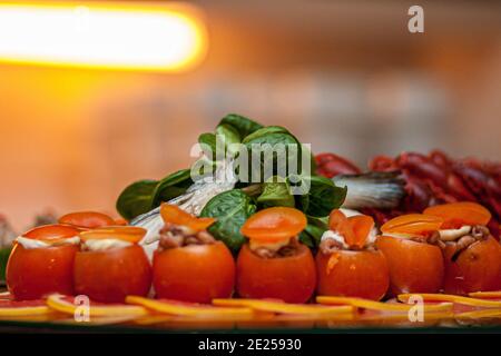 Raw tomatoes stuffed with shrimps and vegetable salad. High quality photo Stock Photo
