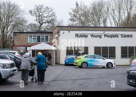 Ruislip, UK.  12 January 2021.  Patients enter a coronavirus vaccination centre at the Ruislip Young People’s Centre in Ruislip, north west London.   This Community Vaccine Hub is one of two which have been set up in the London Borough of Hillingdon (the other is in Hayes).  So far, approximately 2.3m people in the UK have received their first dose of the vaccine as at 10 January.  Credit: Stephen Chung / Alamy Live News Stock Photo