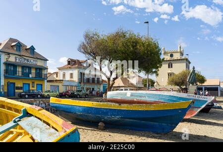 Traditional fishing boats on the beach of the harbor, landmark Torre de Belem in the background. City Mindelo, a seaport on the island  Sao Vicente, Stock Photo