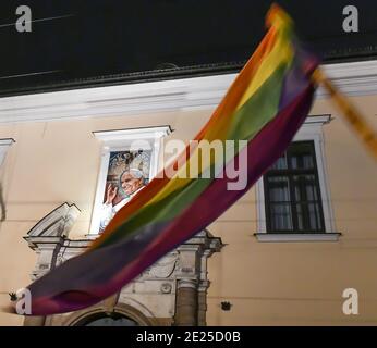 An LGBT flag flown over the portrait of  Pope John Paul II during the protest in Krakow.A protest against Archbishop Marek Jedraszewsk was organized in front of the Curia headquarters in Krakow by the All-Poland Women's Strike in response to the tightening of the abortion law and hiding Pedophilia in the Catholic church. Stock Photo