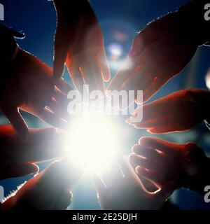 close up. young business people joining their palms in a circle. Stock Photo