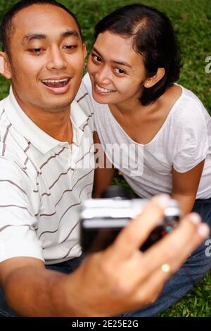 asian ethnic young couple happy taking self portrait Stock Photo