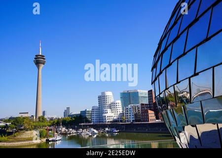 Panoramic view of Medienhafen with Rhine Tower and Gehry Buildings. On the right side in front, the silver construction of Pepple's Bar is visible. Stock Photo