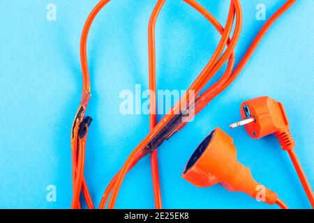 burnt electrical wire on blue background. Stock Photo