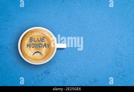 Sade face in cup of coffee. Blue Monday concept. Stock Photo