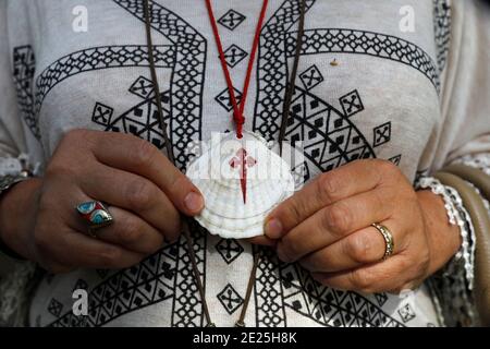 Notre Dame (Our Lady) church, Ajou, France. Artist's scallop shell pendant. Stock Photo