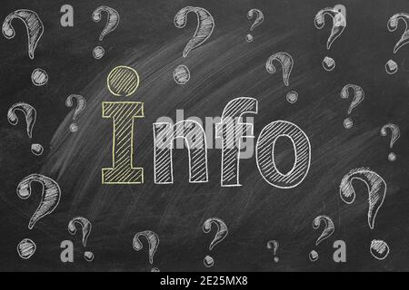 Lettering INFO and question marks drawn in chalk on a blackboard. Information support, customer support. FAQ concept. Stock Photo