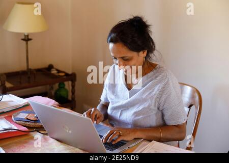 Woman working from home on a laptop. Eure, France. Stock Photo