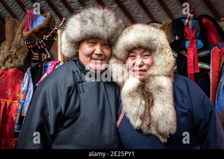 Naryn-Atsagat zone, near Oulan Oude (ulan ude), Siberia, Russia - Mars 09, 2020 : Couple of Buryats  in traditional costumes with their horse. Stock Photo