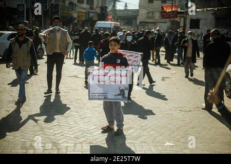 Gaza, Palestine. 12th Jan 2021. Palestinians protest against reduction of the UN Relief and Works Agency for Palestine Refugees 'UNRWA' services provided by the Palestinian refugees, in the Jabalya refugee camp, in Gaza, Palestine, on January 12, 2021. Photo by Ramez Habboub/ABACAPRESS.COM Credit: Abaca Press/Alamy Live News Stock Photo