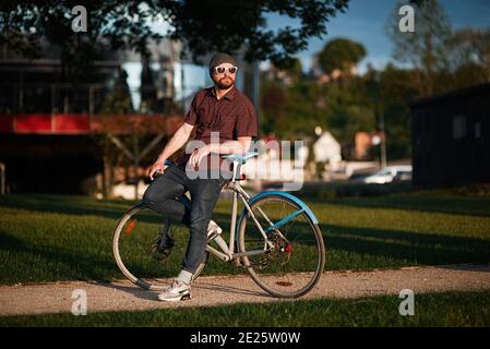 A handsome male with bicycle and backpack Stock Photo