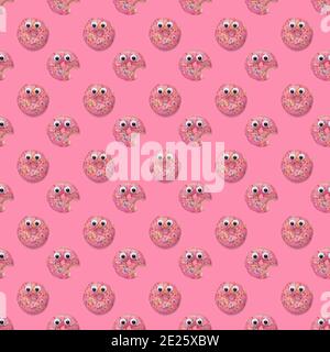 Seamless repeating pattern of pink dougnuts donuts with sprinkles and googly eyes on a pink background. Stock Photo