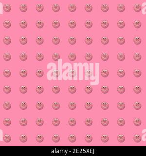 repeating pattern of pink donut doughnut with sprinkles on a pink background Stock Photo