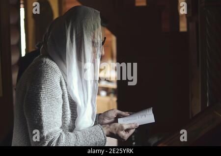 Christian woman praying in church, close up Stock Photo