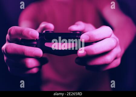 Closeup shot of a person's hands holding a joystick and playing games Stock Photo