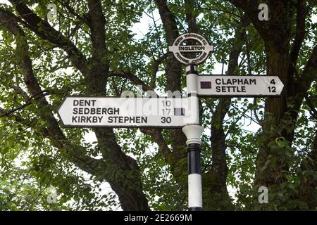 Pennine Cycleway direction and distance signpost in Ingleton, North Yorkshire Stock Photo