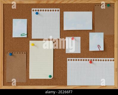 cork board with blank papers wooden frame. notes. colourful pin and paperclips . reminder. pin board. isolated. new year's resolution, goals. Stock Photo