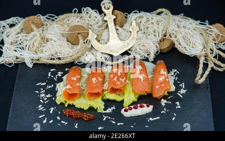 smoked norwegian Salmon in front of a fishing net Stock Photo